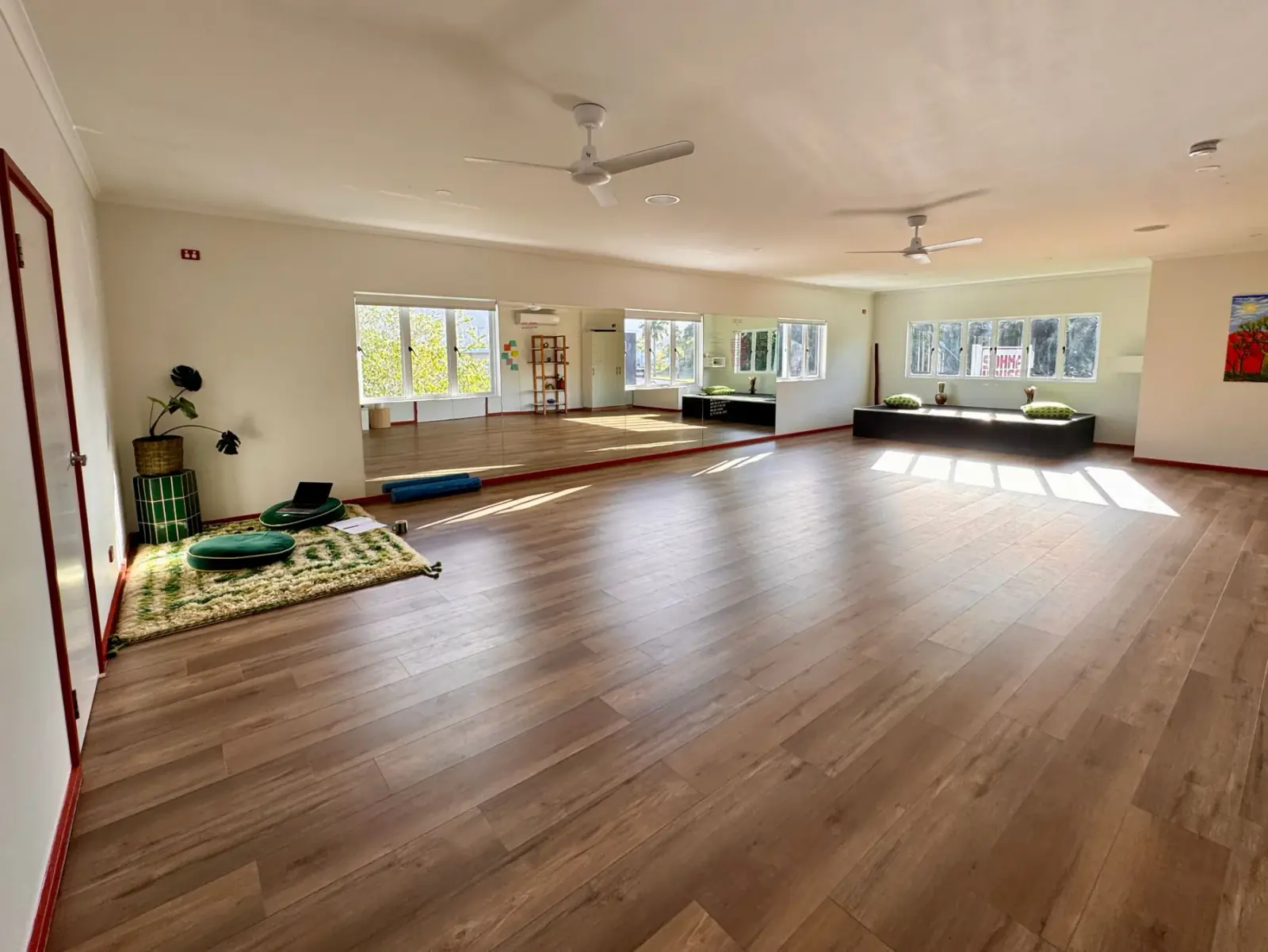 The long bench under the studio windows upstairs, with sun on the timber floor